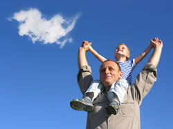 father carrying son on shoulders